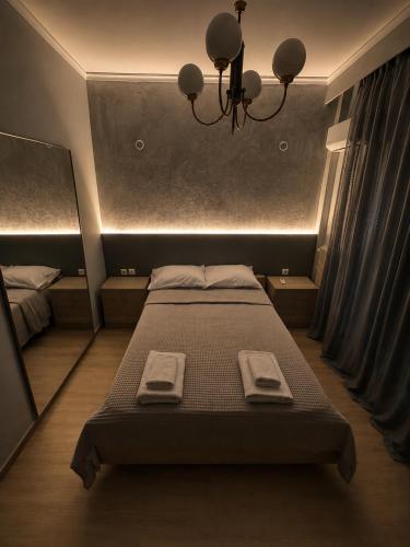 a bedroom with a bed with two towels on it at Διαμέρισμα 4 dimos in Alexandroupoli
