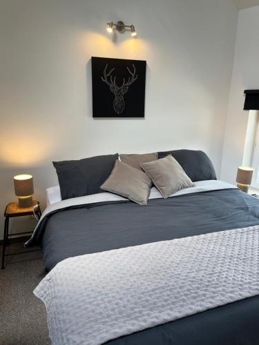 a bedroom with a bed with a black picture on the wall at Week end à Spa in Spa
