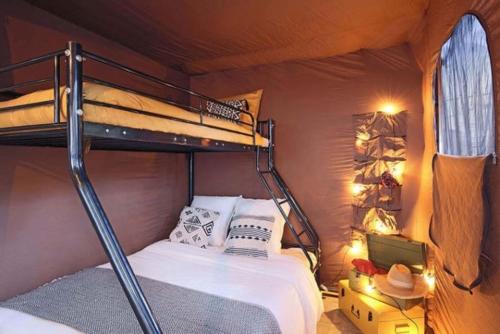 a bedroom with two bunk beds in a room at Camping du Lac de Cazaux in La Teste-de-Buch