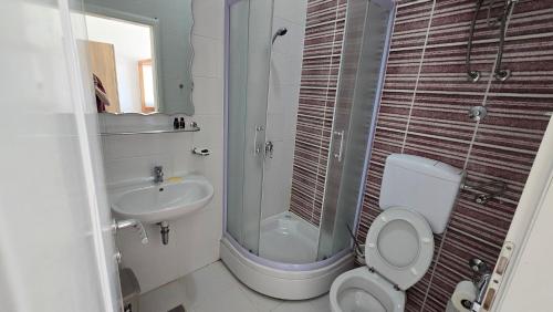 a bathroom with a shower and a toilet and a sink at منتجع سراييفو - Sarajevo Resort in Sarajevo