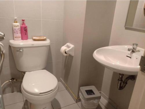a bathroom with a toilet and a sink at Sea View Residence in Cha Am