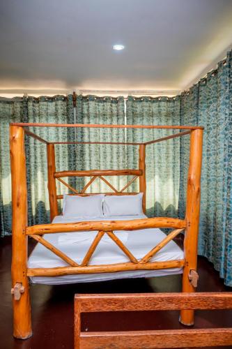 a wooden bed with two pillows in a room at Marumbi Beach House in Marumbi