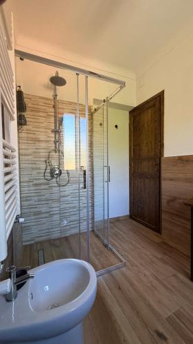 a bathroom with a sink and a glass shower at Piano Piano Affittacamere in Andagna