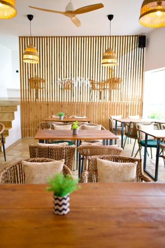 a restaurant with wooden tables and chairs and lights at SANIMAR By Mono Alex in Kassandra