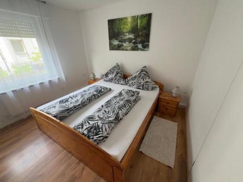 a bed in a small room with a window at Zentral in Siegen