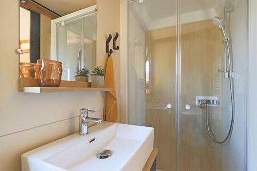 a bathroom with a sink and a shower at Camping du Lac de Cazaux in La Teste-de-Buch