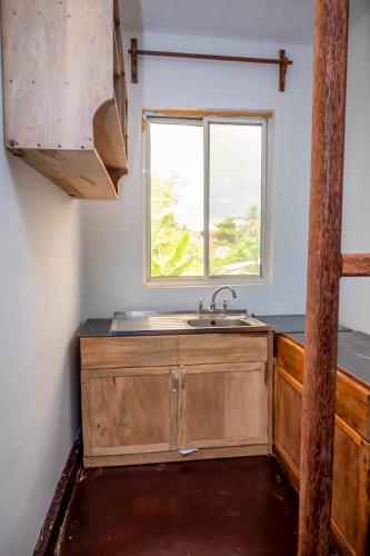 a kitchen with a sink and a window at Marumbi Beach House in Marumbi