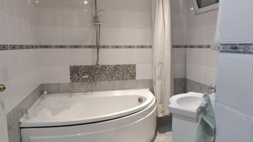 a bathroom with a white tub and a toilet at Villa Toni in Varna City