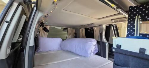 an inside of a camper van with purple pillows at Campvan Stay in Auckland