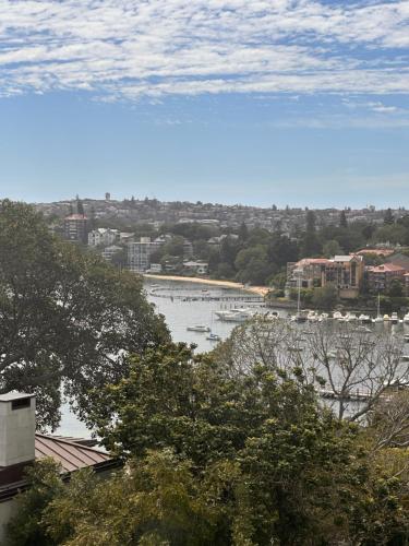 a view of a river with a city in the background at Darling Point with Harbour Views in Sydney