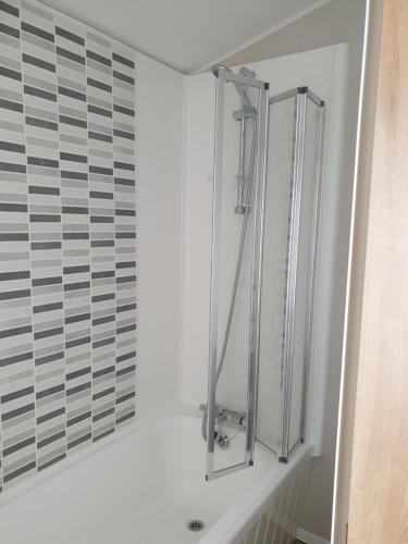 a shower in a bathroom with a white wall at K7 Annandale in Winthorpe