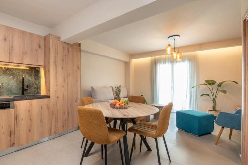 a kitchen and dining room with a table and chairs at Sea View in Laganas