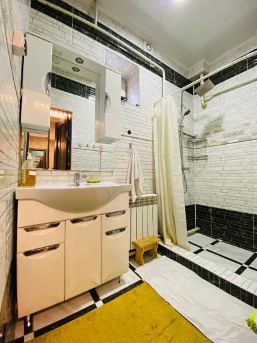 a bathroom with a sink and a shower at Guest house Nuri in Karakol