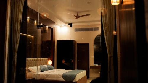a bedroom with a bed in a room with a window at Sandy Resort in Agastīswaram