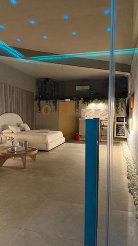 a large living room with a bed and a table at BREATH47SPA - Private Spa Suite White Jacuzzi & Sauna in Marbella in Marbella