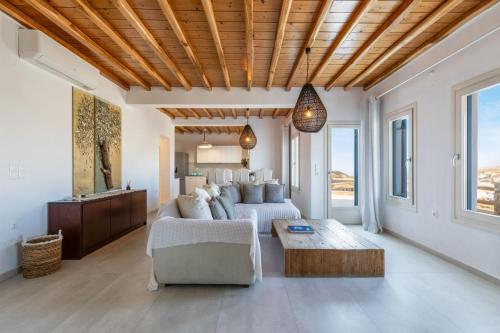 a living room with a couch and a table at Villa Sun Sky in Aggelika