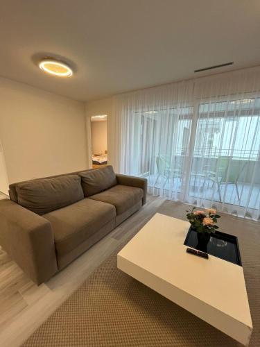 a living room with a couch and a coffee table at Cozy apartment in Zurich