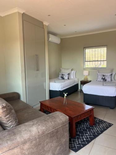 a living room with two beds and a couch at Wonderwerk cave adventures in Kuruman