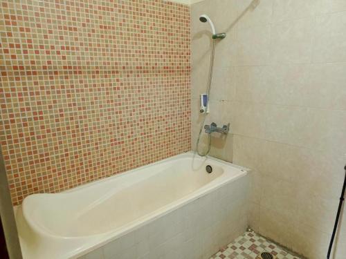 a bathroom with a bath tub and a shower at Melati resort kuta lombok in Kuta Lombok