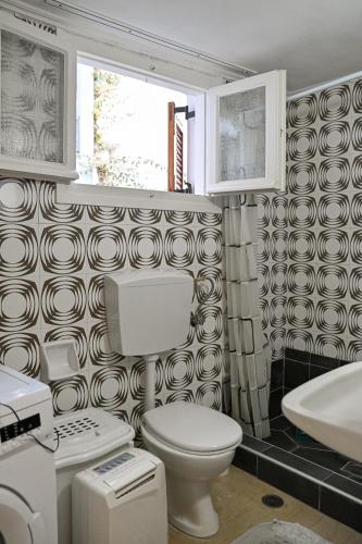 a bathroom with a toilet and a sink at BotaniCasa by WENS in Preveza