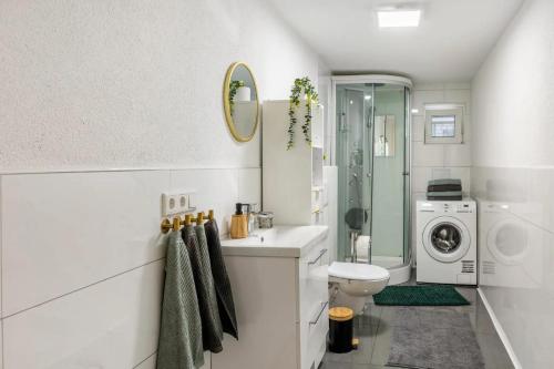 a bathroom with a sink and a washing machine at Schöne Wohnung in ruhiger Gegend in Calden