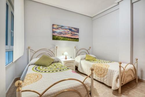 two beds in a room with white walls at CaTere Estancia Bocairent in Bocairent