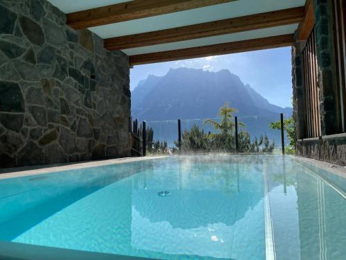 a swimming pool with a view of a mountain at Zugspitzblick - pur! in Lermoos
