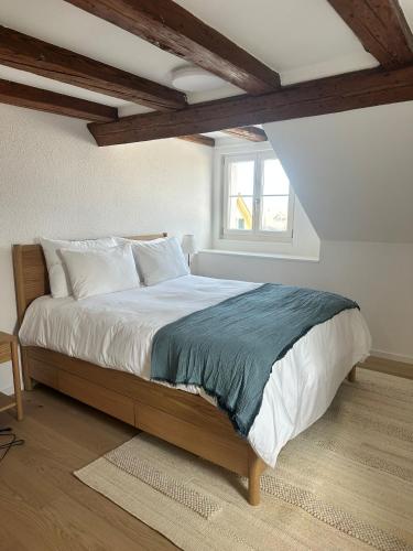 a bedroom with a large bed in a attic at Stadtloft Suites Richterswil in Richterswil