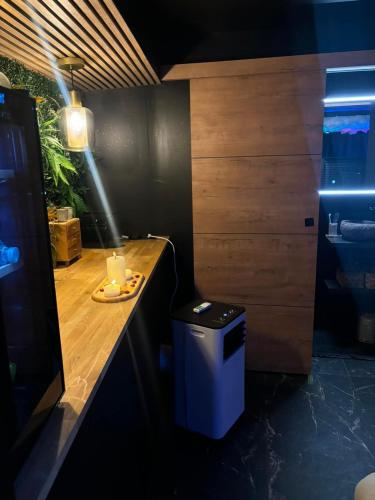 a kitchen with a counter with a trash can at L'écrin Secret Suite & NETFLIX Aubagne-Cassis-Marseille in Aubagne
