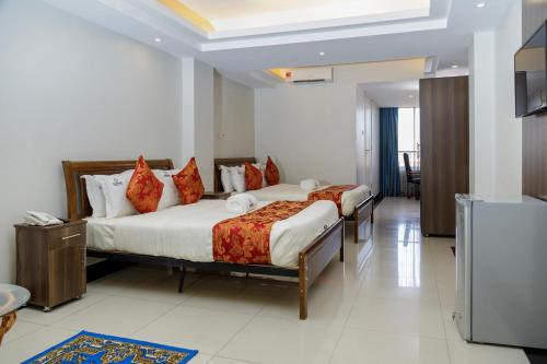a bedroom with two beds in a room at Grand Plaza Hotel in Kampala