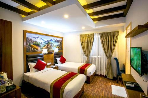a hotel room with two beds and a television at Beautiful Kathmandu Swimming pool Hotel in Kathmandu