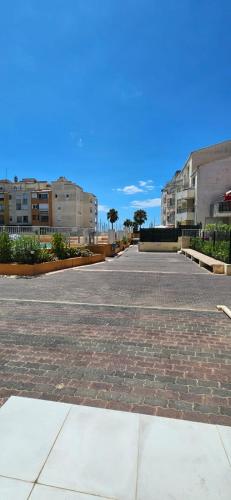 an empty parking lot in a city with buildings at Le paradis du Port Cozy studio near port and beaches in Cap dAgde in Cap d'Agde
