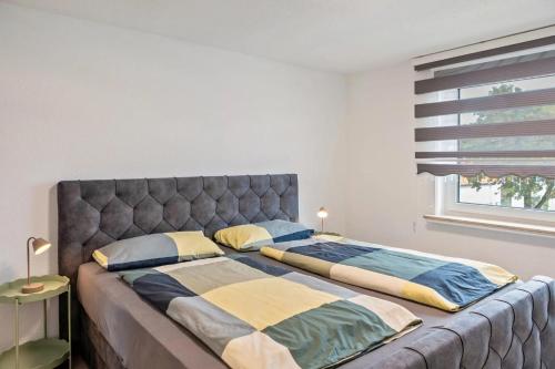 a large bed with two pillows on it in a bedroom at Schöne Wohnung in ruhiger Gegend in Calden