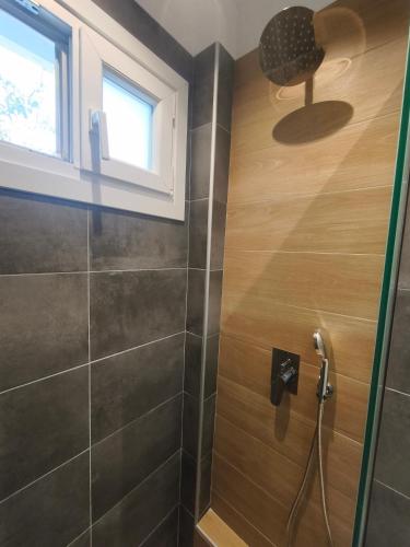 a bathroom with a shower with a glass door at Skalopati Studios & Villa in Panormos Skopelos