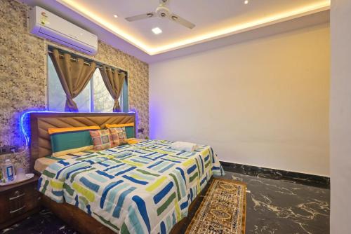 a bedroom with a large bed in a room at II EMPYREAN STAYS II AURA VILLA II 3BHK II AC II LARGE POOL Il in Lonavala
