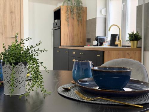 a table with a plate and a bowl on it at Sopianae Apartments in Pécs