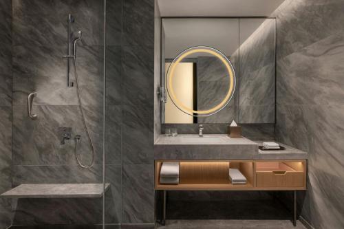 a bathroom with a sink and a shower at Courtyard By Marriott Tirupati in Tirupati