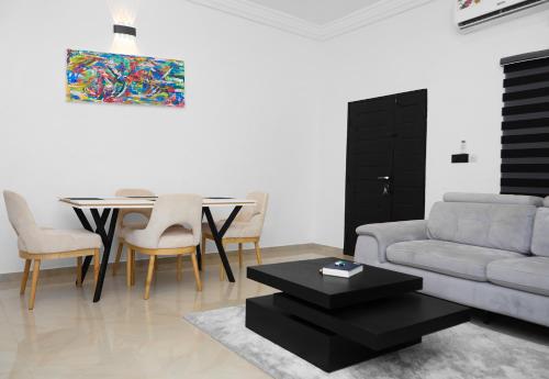 a living room with a couch and a table at IGBADUN House in Godomey