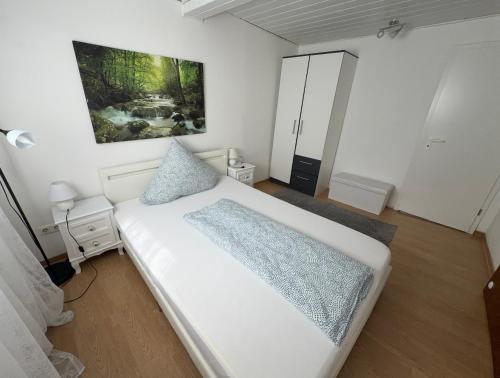 a bedroom with a white bed and a painting on the wall at Zentral Z in Siegen