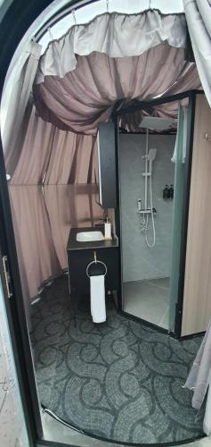 a small tent with a sink and a tv in it at Maremonti Glamping in Ancarano