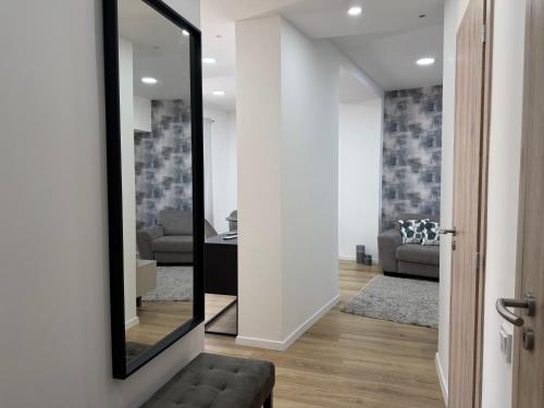 a mirror on the wall of a living room at Sopianae Apartments in Pécs