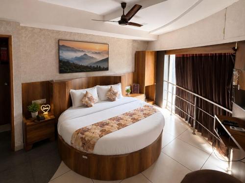 a bedroom with a large bed in a room at Star Hotel in Ahmedabad