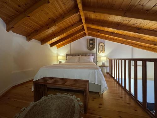a bedroom with a bed in a room with wooden ceilings at Mersea deluxe apartment Kourouta in Kourouta