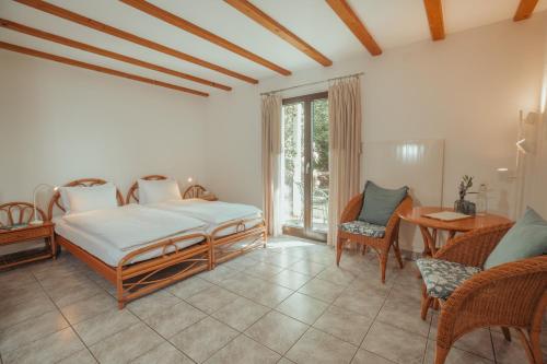 a bedroom with a bed and a table and chairs at Hotel Sass da Grüm in Vairano