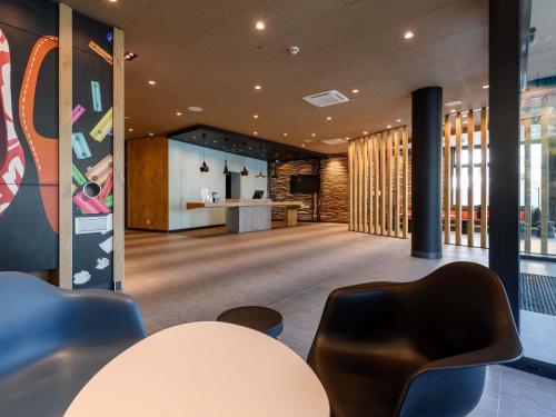 a conference room with a table and chairs at ibis Regensburg Zentrum in Regensburg