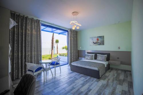 a bedroom with a bed and a table and chairs at Relax Beach Astara in Astara