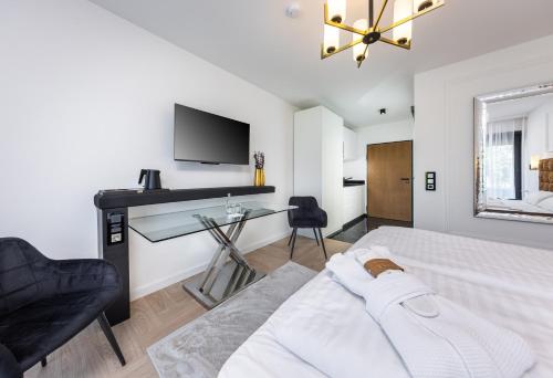 a bedroom with a bed and a desk and a tv at Ferienwohnung 210 Salinenparc Design Budget Hotel in Erwitte