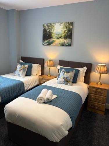 a bedroom with two beds with towels on them at The Pod on John St in Wexford