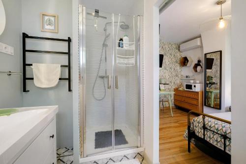 a bathroom with a shower and a sink at Les Arbousiers in Saint-Raphaël