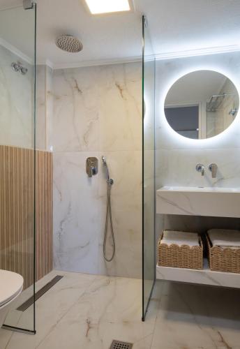 a bathroom with a shower and a sink at Tsamakdas House in Toroni